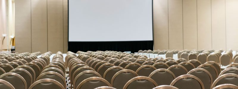 Countless perfectly arranged chairs in a presentation room.