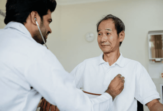 doctor checking heartbeat