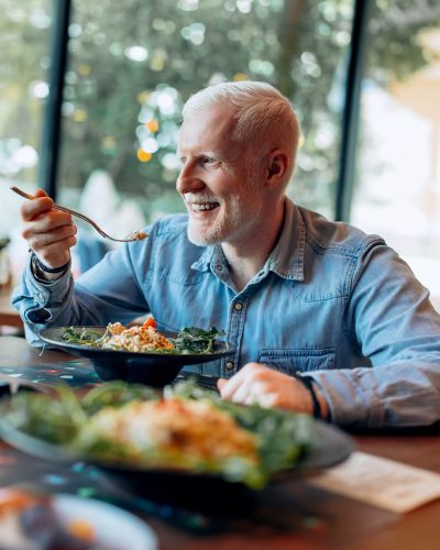An older man eating a healthy meal.